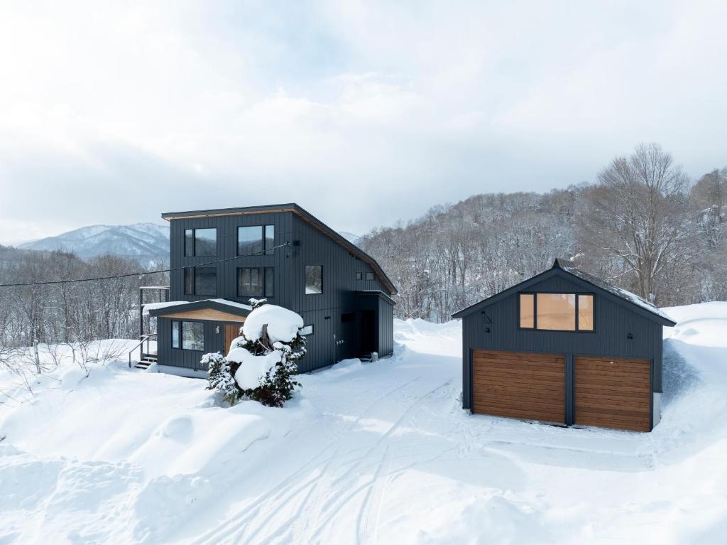 a couple of buildings in the snow at Kogane Hills Niseko in Rankoshi