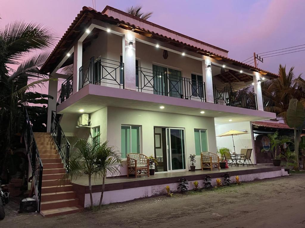 a house with stairs and chairs in front of it at Bungalows Garza Blanca a Pie de Playa in San Blas