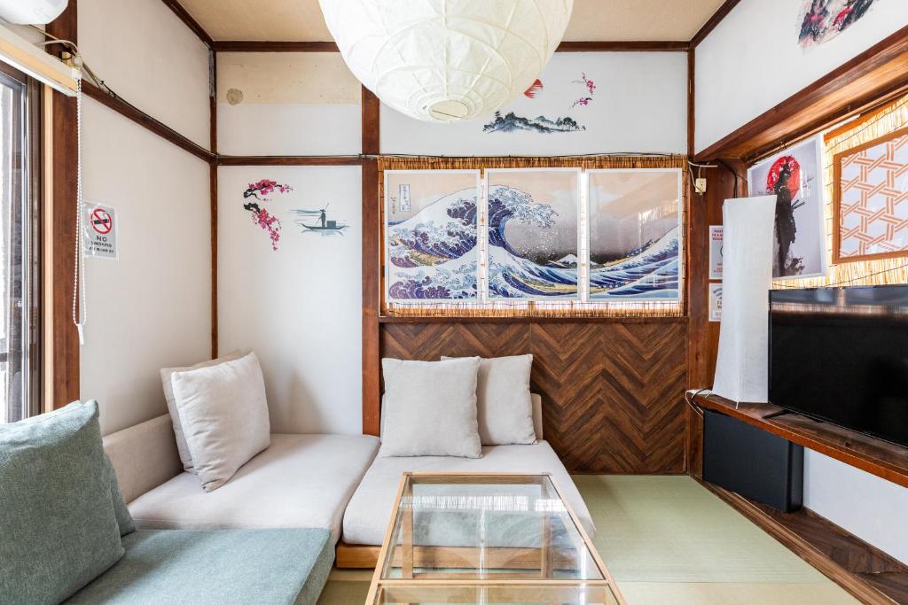 a living room with a couch and a glass table at 弥生町1丁目戸建 in Tokyo