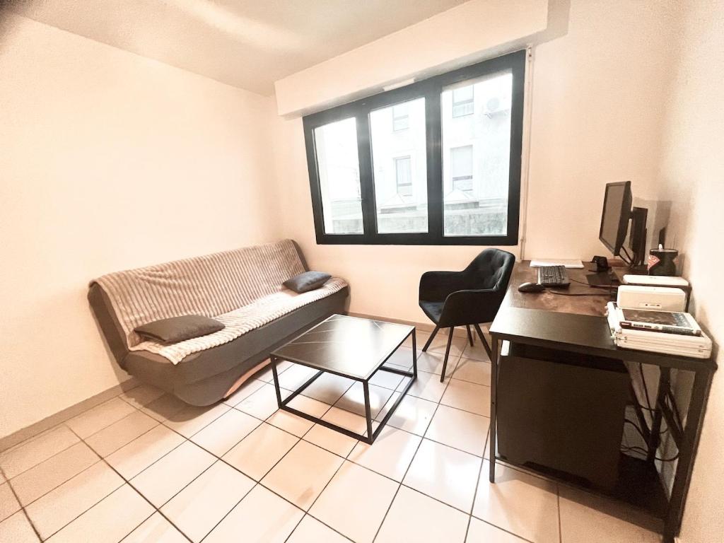 a small living room with a couch and a desk at Salon de Provence in Salon-de-Provence