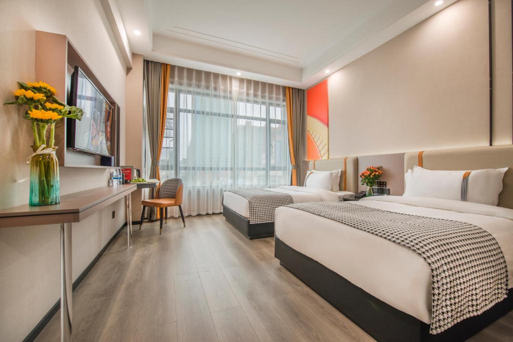 Voodi või voodid majutusasutuse Xiyueliang Hotel Kunming South Asian Style First City Branch toas