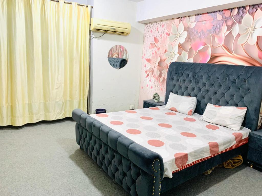a bedroom with a bed with a polka dot mattress at Peaceful Living Appartment in Rawalpindi