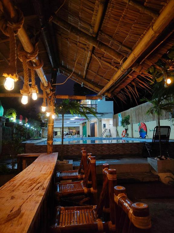 a bar with a long wooden table and chairs at Aloha Ocean View Resort in Pandan