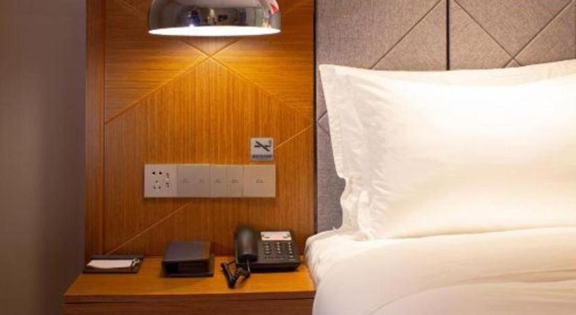 Cama o camas de una habitación en Borrman Hotel Zhanjiang Xuwen Port Terminal