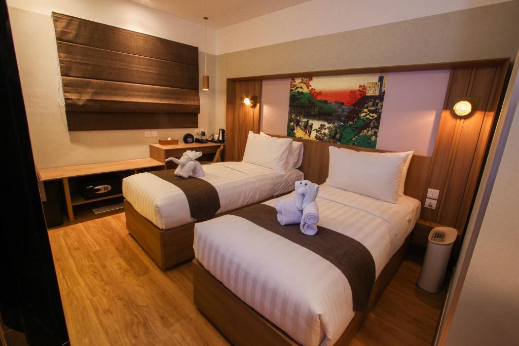 Postel nebo postele na pokoji v ubytování Kuretakeso Kemang Hotel