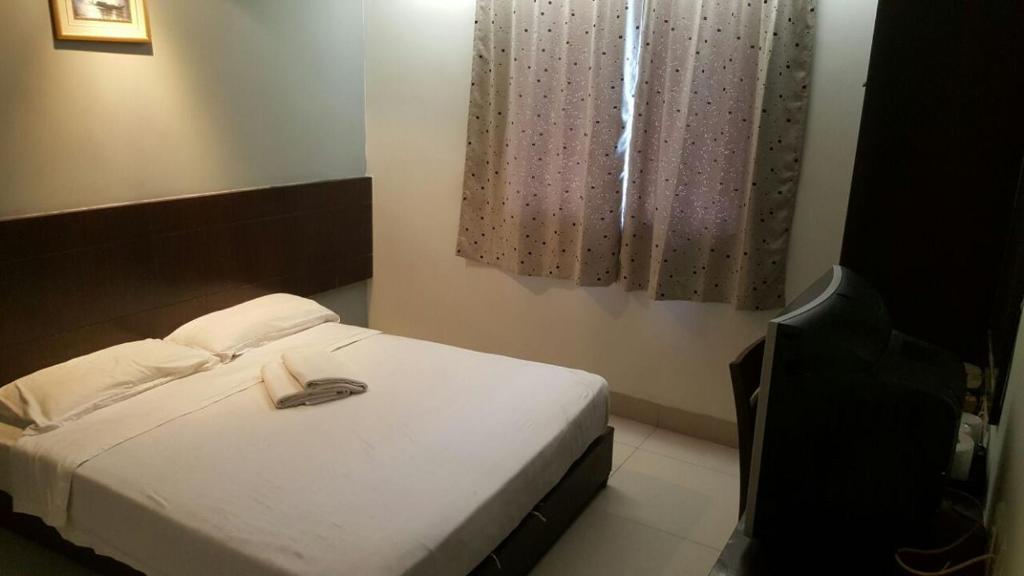 Postel nebo postele na pokoji v ubytování Tiong Nam Hotel