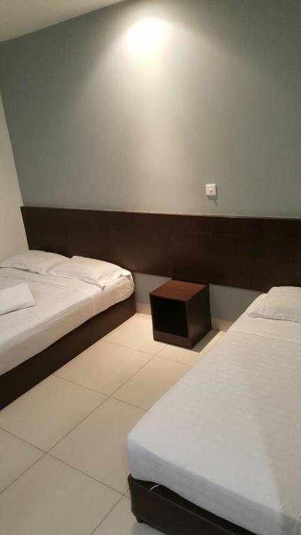 Postel nebo postele na pokoji v ubytování Tiong Nam Hotel