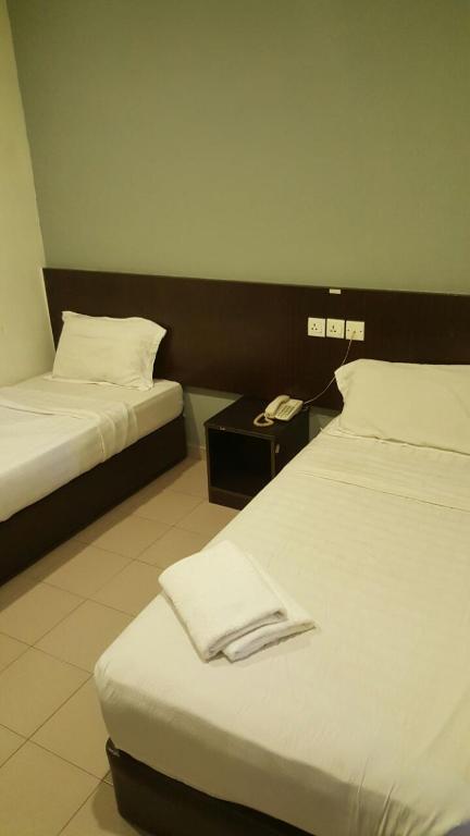 Postel nebo postele na pokoji v ubytování Tiong Nam Hotel