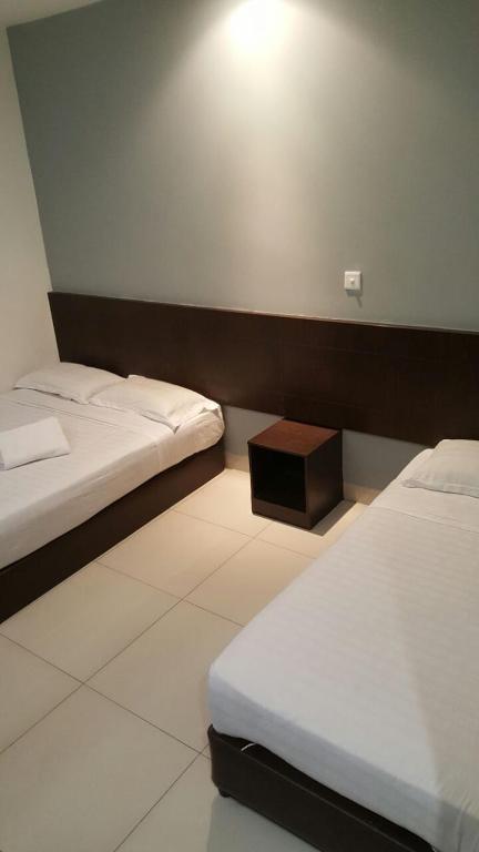 Postel nebo postele na pokoji v ubytování Tiong Nam Hotel