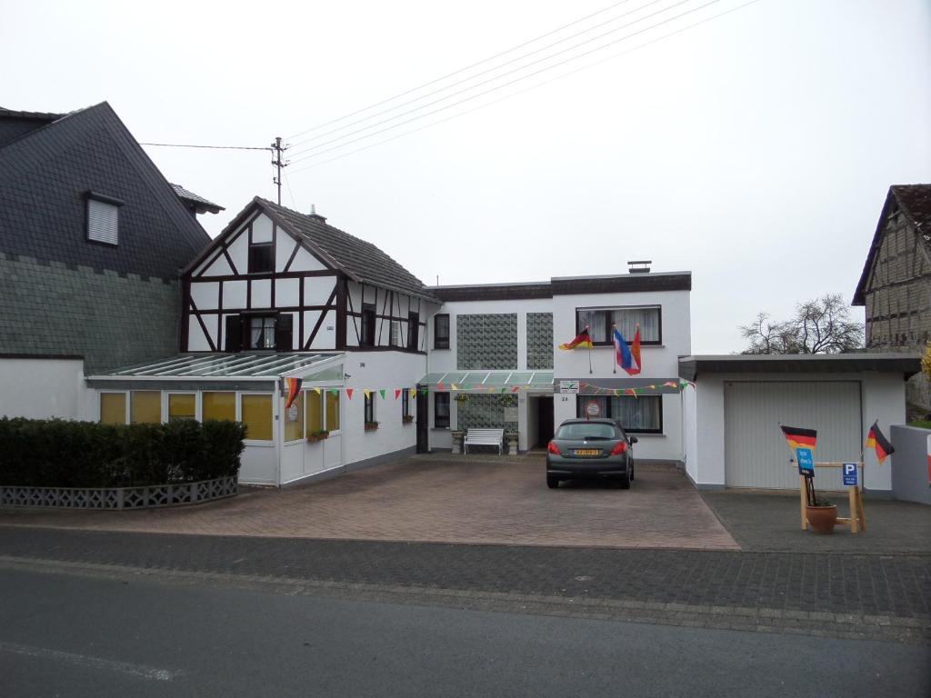 a car parked in a parking lot in front of a building at Historisches Fachwerkhaus in Reifferscheid