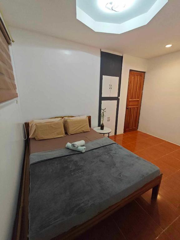 a bedroom with a large bed in a room at Alexa's Apartments in El Nido