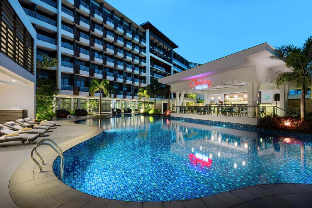 a large swimming pool in front of a hotel at Poolside Escape Near Boracay's Iconic Keyhole in Boracay