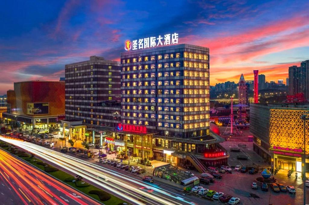 a city skyline with a building and traffic at night at Shengming International Hotel - Free shuttle service to Chongqing Jiangbei Airport in Chongqing