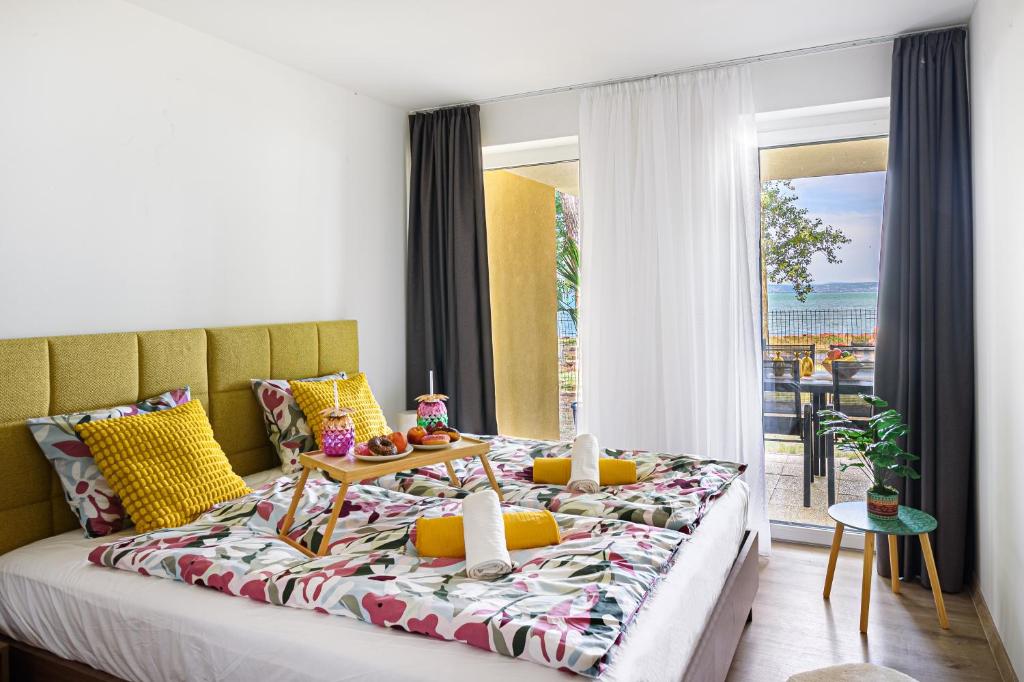 a bedroom with a bed with a view of the ocean at Karolina - Winter Holidays in Siófok