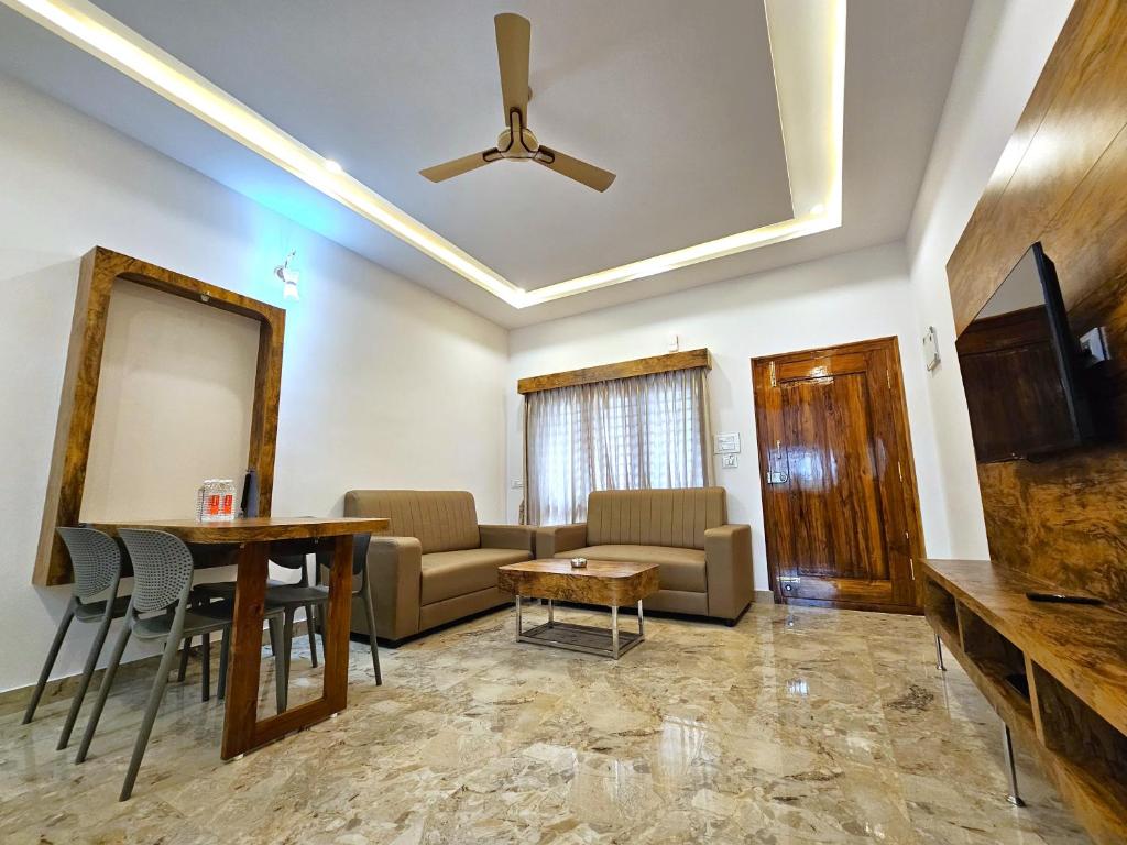a living room with a couch and a table at City Service Apartment in Chikmagalūr