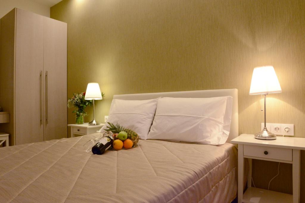 a bedroom with a bed and a lamp at Phidias Hotel in Athens