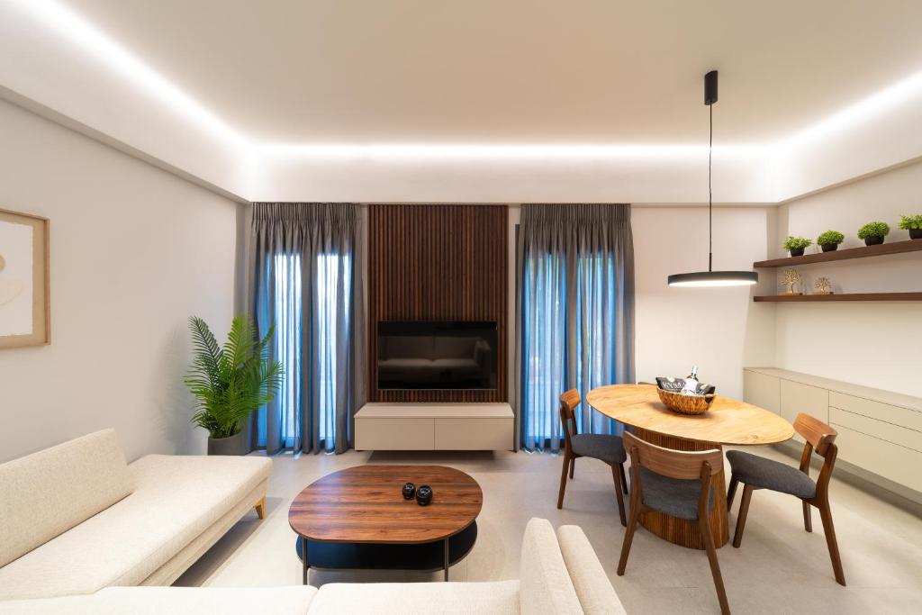 a living room with a table and a couch at Kyma Luxury Apartment in Rhodes Town