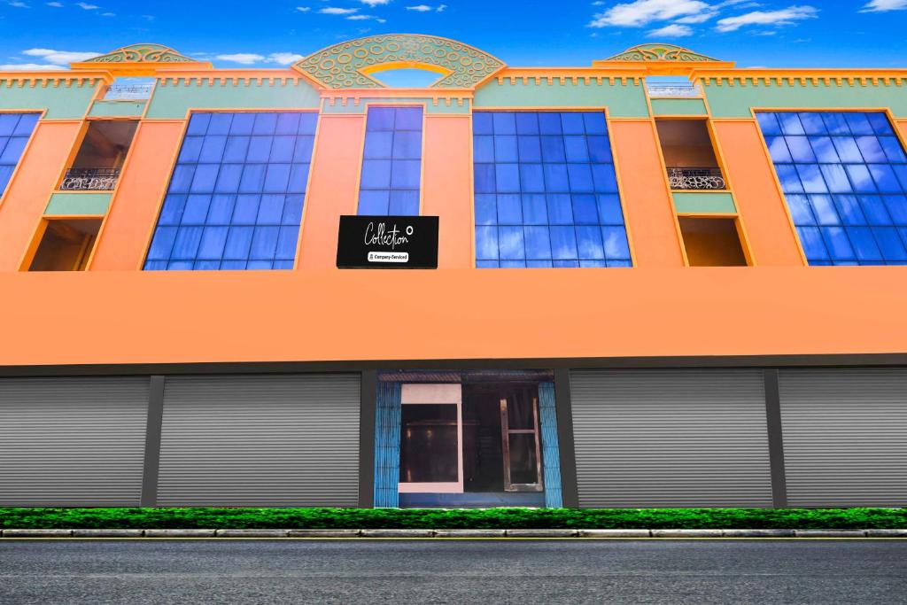 an orange building with a black sign on it at Collection O Rayagada Bus Stand in Rāyagada