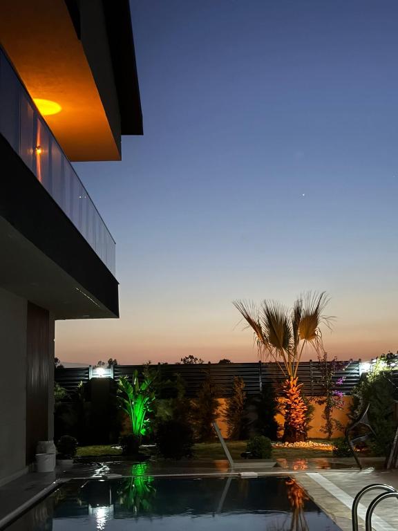 a night view of a building and a swimming pool at Belek Seven Luxury in Belek