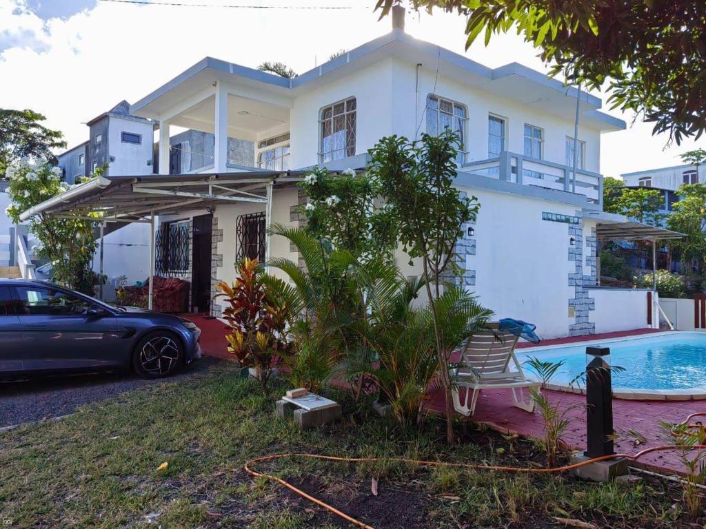 a house with a car parked in front of it at Sandy Home in Grande Gaube