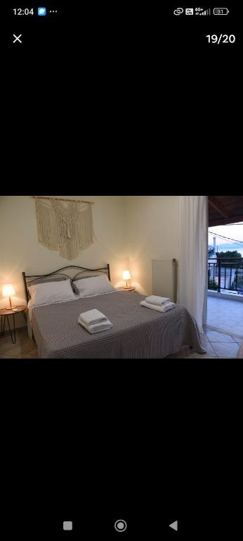 a bedroom with a bed with two towels on it at Denaxas apartments 0 in Elia Laconias