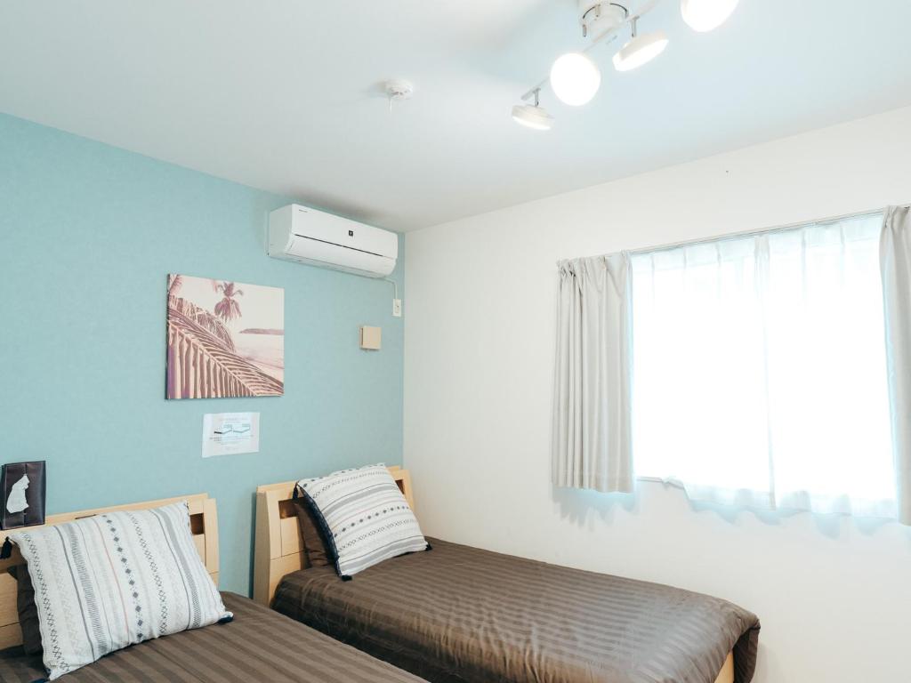 Postel nebo postele na pokoji v ubytování Base in Onnason,Okinanawa