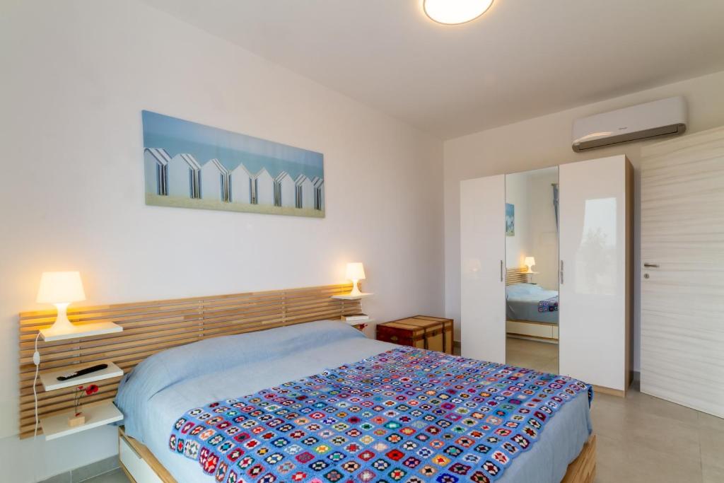 a bedroom with a large bed in a room at Marzamemi Holidaydream Sea View in Marzamemi