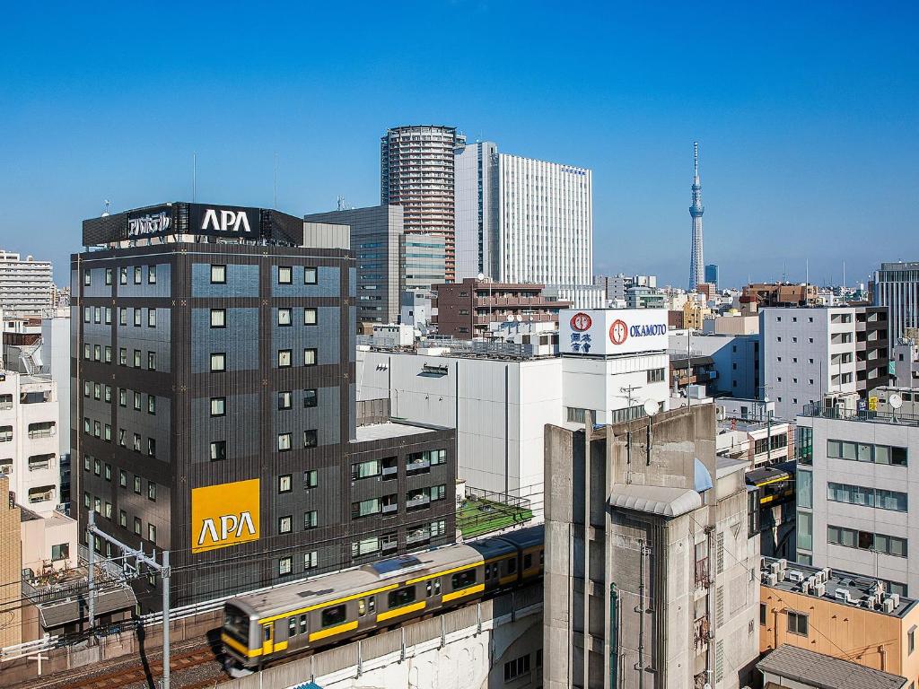a view of a city skyline with a train at APA Hotel Akihabara Ekimae in Tokyo