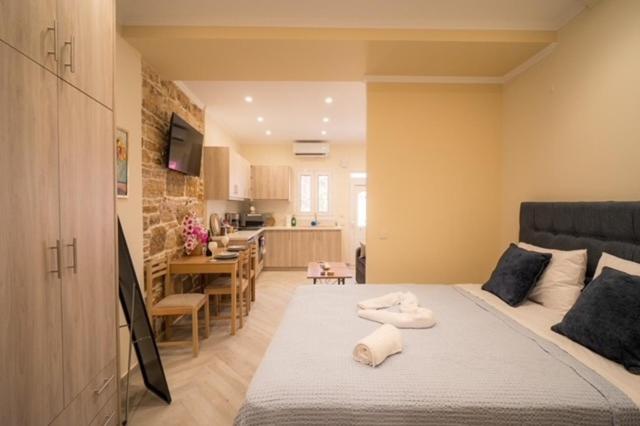 a bedroom with a large bed and a kitchen at Georgia studio in Chios