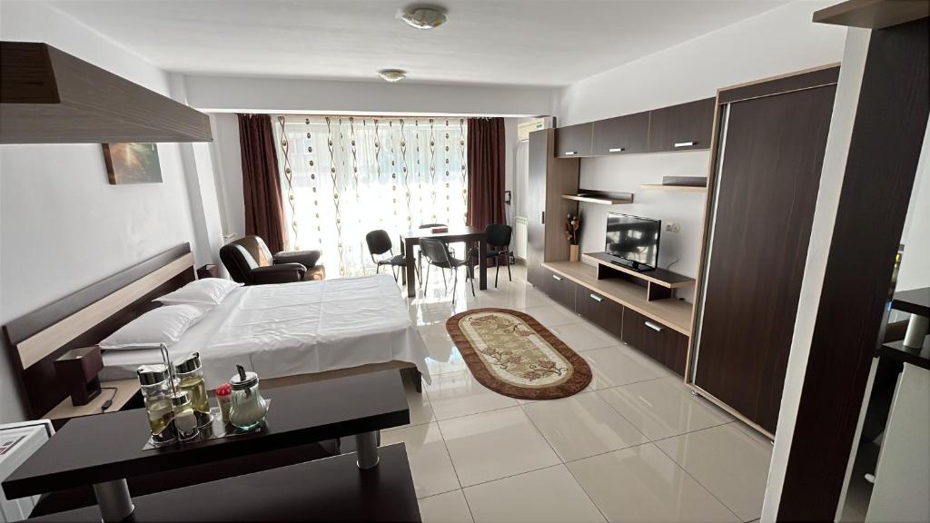 a hotel room with a bed and a living room at Cazare Mangalia - Self Check-in in Mangalia