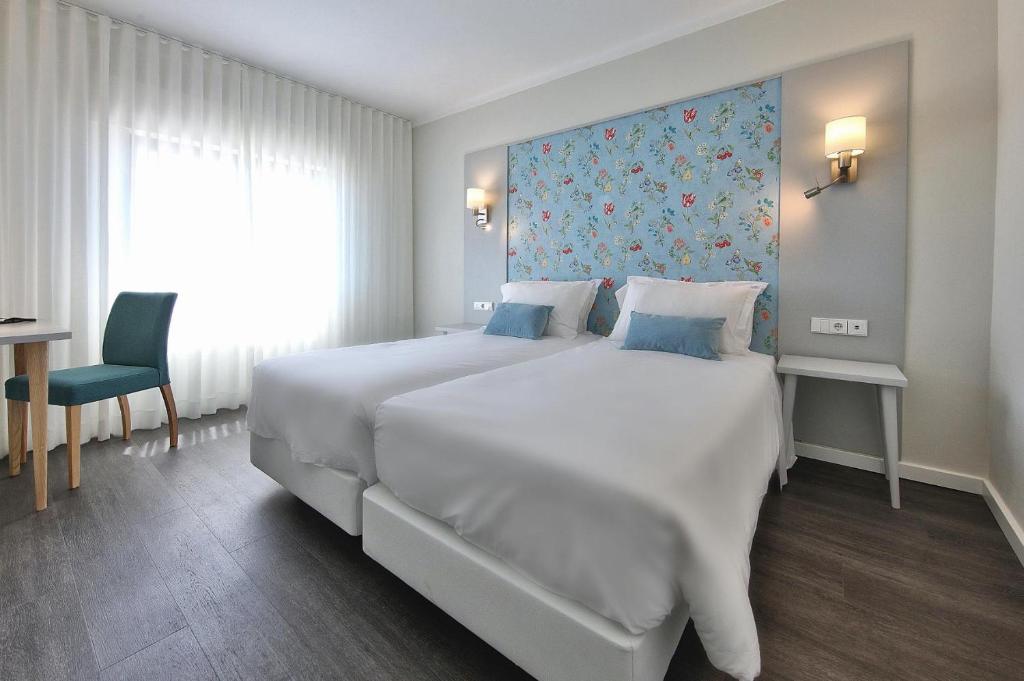 Кровать или кровати в номере Agua Hotels Alvor Jardim
