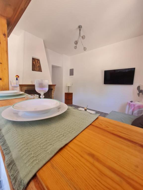 a plate sitting on top of a wooden table at Modern traditional tranquil house with garden in Nea Makri