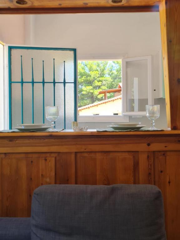 a counter with two wine glasses and a mirror at Modern traditional tranquil house with garden in Nea Makri