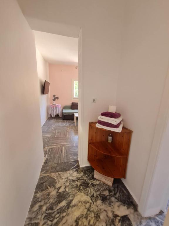 a hallway of a room with a table and a room with at Modern traditional tranquil house with garden in Nea Makri