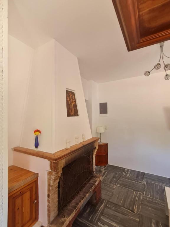 a living room with a fireplace in a house at Modern traditional tranquil house with garden in Nea Makri