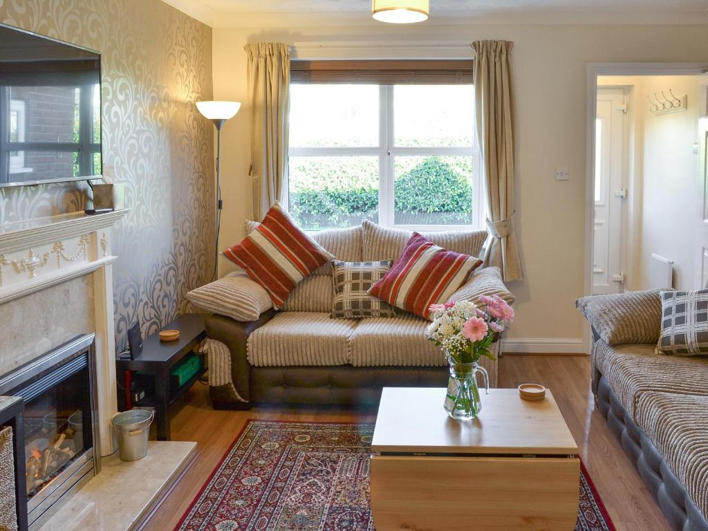 a living room with a couch and a fireplace at Signals Court in Scarborough