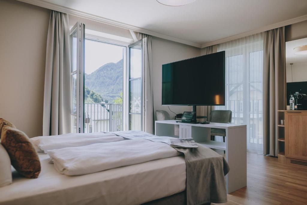 una camera da letto con un letto e una grande finestra di Grand Elisabeth a Bad Ischl