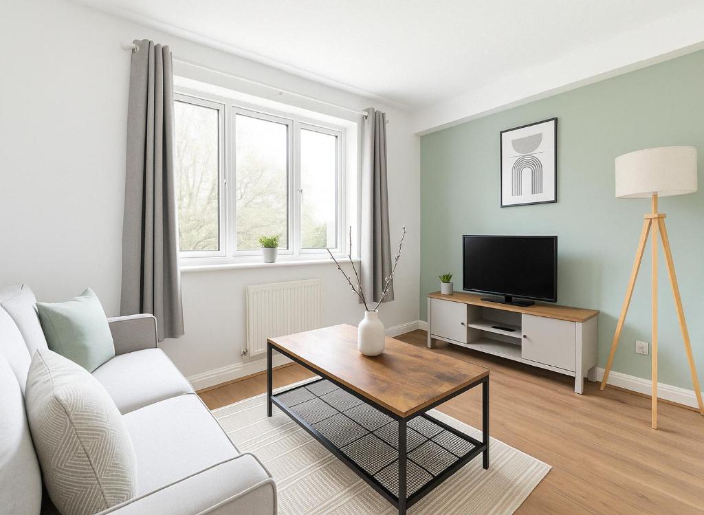 Una sala de estar con un sofá y una mesa con televisión. en Modern Flat near Tower Bridge, en Londres
