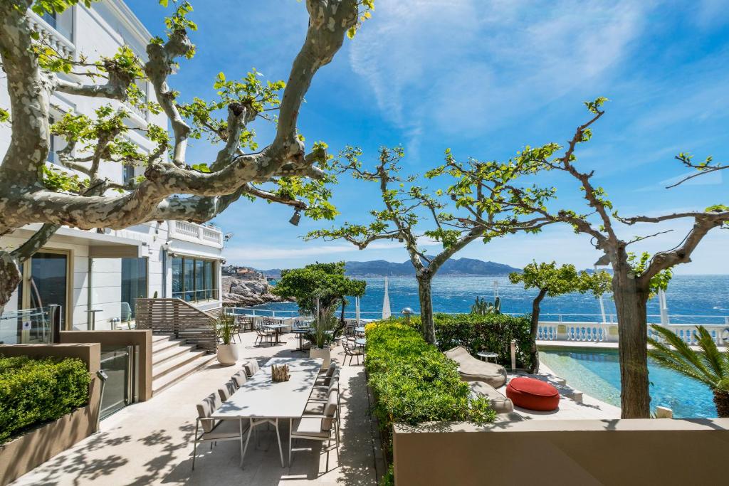 a view of the ocean from the balcony of a house at Le Petit Nice - Passedat in Marseille