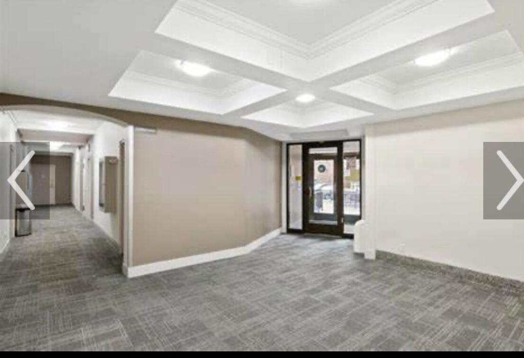 an empty office room with a white ceiling at Welcome to New Rochelle Studio in New Rochelle