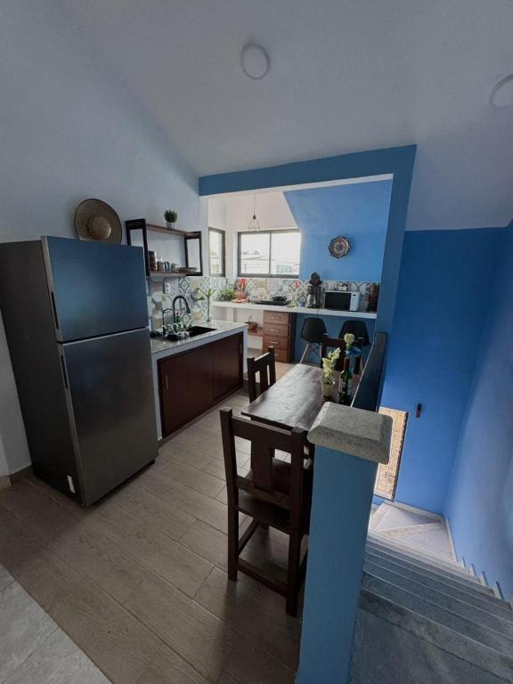 a kitchen with a table and a refrigerator at Coronaditos 2-Bedroom Appartment in Colonos in Valladolid
