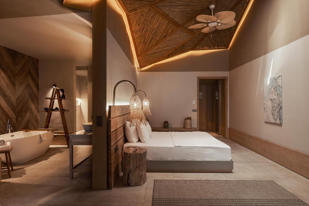 A bed or beds in a room at Day One Beach Resort & SPA - Adult Only