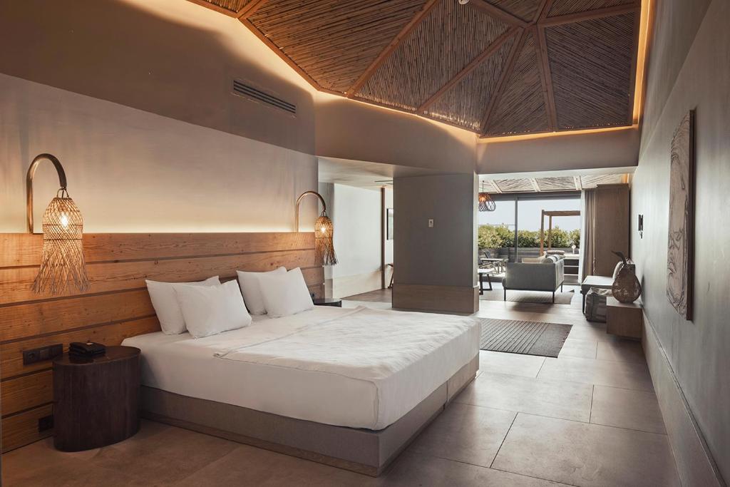 A bed or beds in a room at Day One Beach Resort & SPA - Adult Only