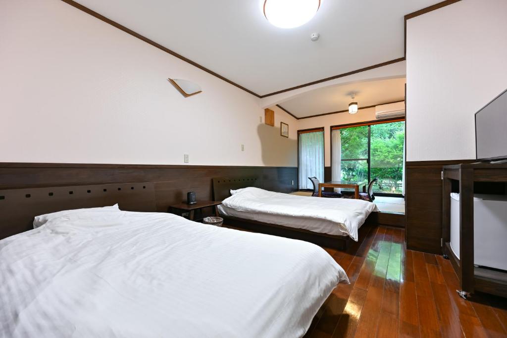Voodi või voodid majutusasutuse 山川温泉 小杉庵 toas