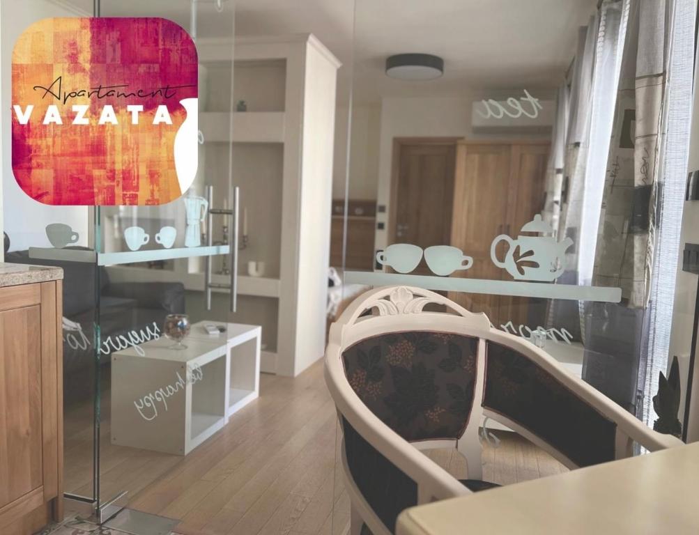 a room with a table and a chair in a room at V A z A T A apartment in Ruse
