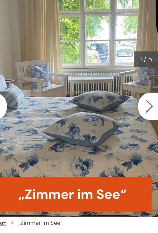 a bedroom with a bed with two pillows on it at Zimmer im See in Niederdorla