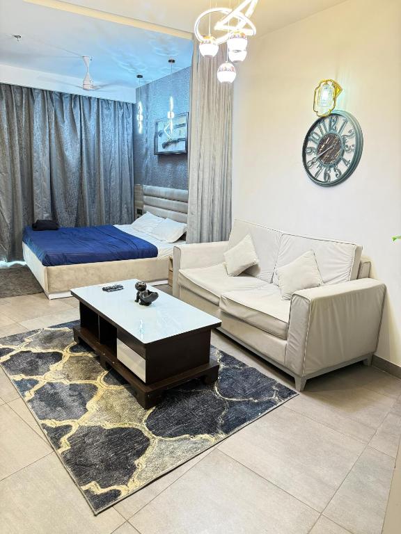 a living room with a couch and a bed at supernova spira in Jāmb