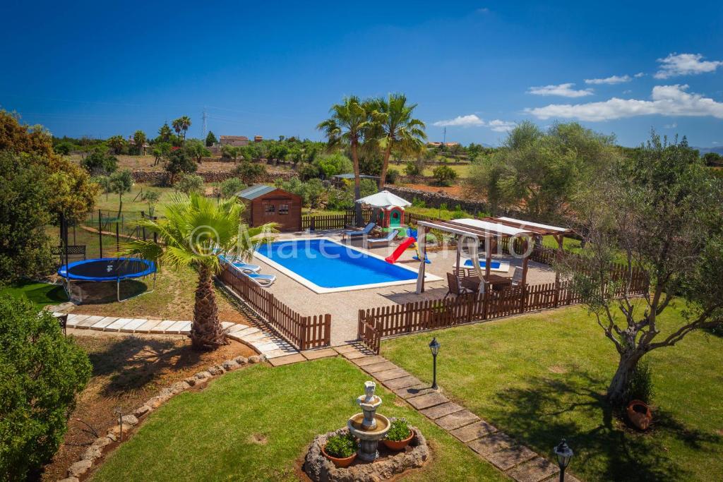 an aerial view of a pool and a playground at Villa Santa Eulalia in Can Picafort