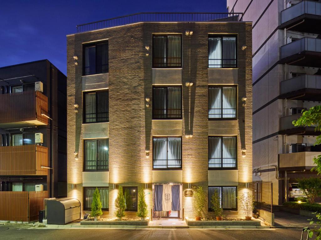an apartment building with lights on the facade at ルチル池袋東京 in Tokyo