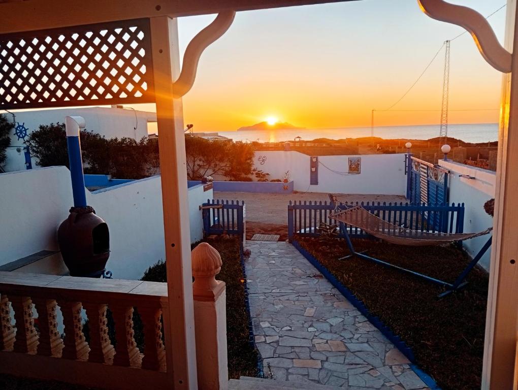 a sunset from the porch of a house at Diar Aquilaria Dar nouha in El Haouaria